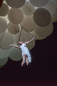 Full length of a young man with balloons