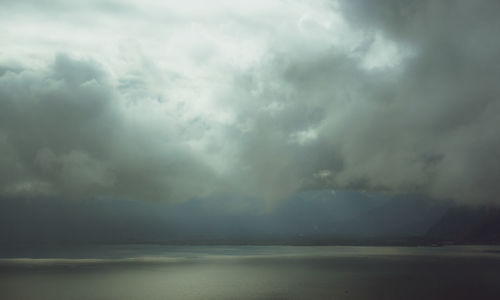 Scenic view of sea against storm clouds