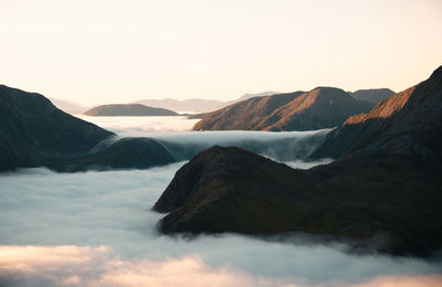 Scenic view of sun-kissed mountains, morning clouds. ideal for nature, landscapes, travel projects.