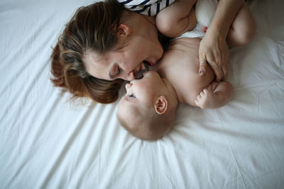 Mother gently hugs son, top view, white background. concept motherhood and emotions.