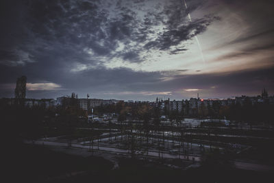 View of cityscape against cloudy sky