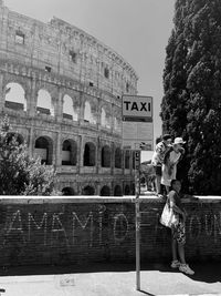 Woman against historic building