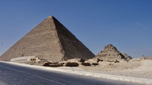 Pyramids on desert against clear sky