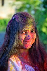 Close-up portrait of smiling young woman with powder paint