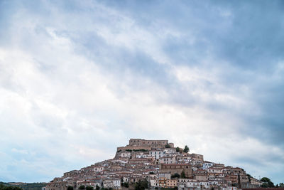 Low angle view of old building against cloudy sky