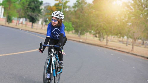 Portrait of man riding bicycle on road