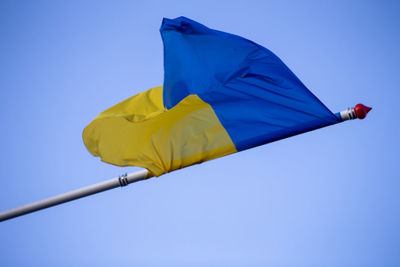 Low angle view of flag against clear sky