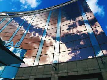 Low angle view of glass building against sky