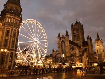 Ferris wheel in city at night