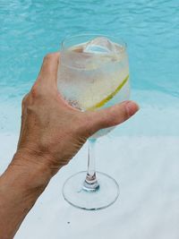 Close-up of hand holding beer glass