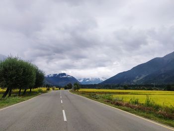 Empty road along countryside landscape