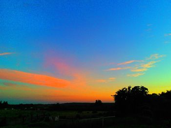 Scenic view of landscape against sky at sunset