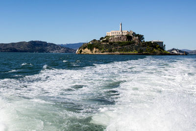Scenic view of sea against clear blue sky