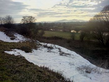 Scenic view of river against sky during winter