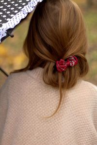 Rear view of woman with pink flower