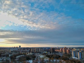 High angle view of buildings against cloudy sky