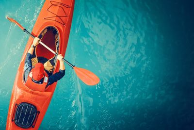 High angle view of mid adult man kayaking on sea