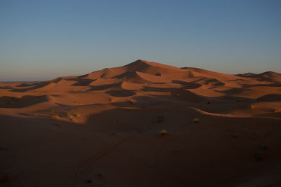 Scenic view of desert against clear sky