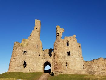 Low angle view of fort against blue sky