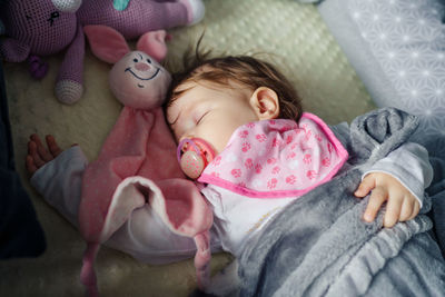 High angle view of baby girl sleeping on bed