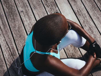 High angle view of woman sitting on pier