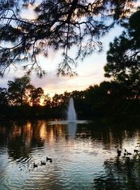 Scenic view of river against sky at sunset