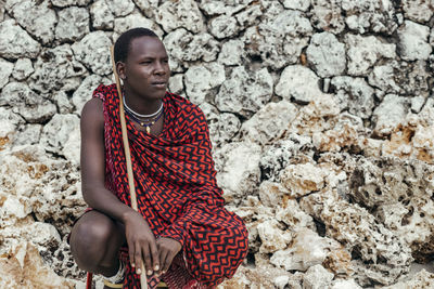 Maasai man on the beach in front of sea