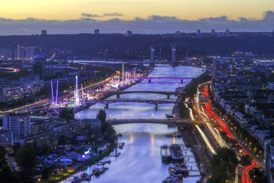 High angle view of illuminated bridge over river in city