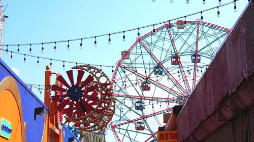 Low angle view of amusement park against clear sky