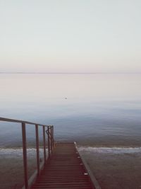 High angle view of steps leading towards lake against clear sky