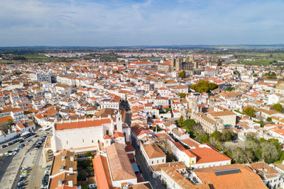 Evora drone aerial view on a sunny day with historic buildings city center in alentejo, portugal