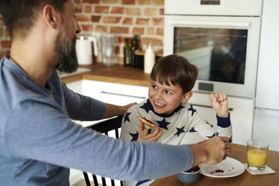 Side view of young man preparing food at home