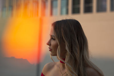 Portrait of young woman looking away outdoors