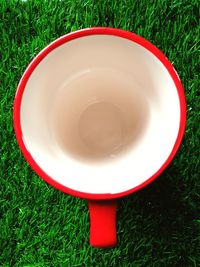 High angle view of empty tea cup on grass