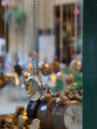 Close-up of stop watch hanging in store
