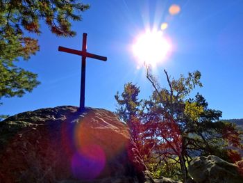 Low angle view of cross on tree against sky