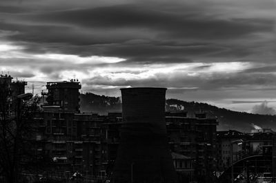 View of cityscape against cloudy sky