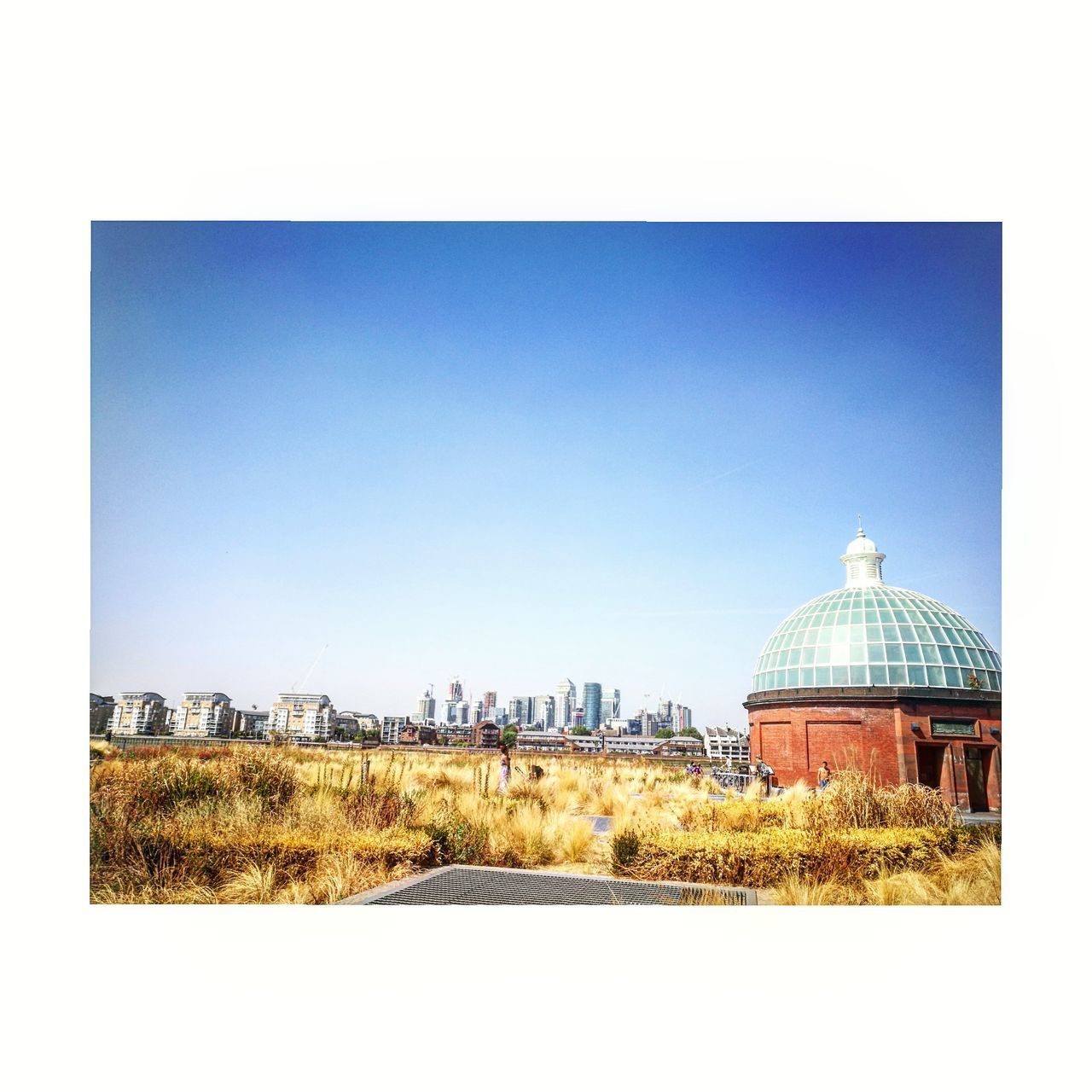 BUILT STRUCTURE ON FIELD AGAINST CLEAR SKY