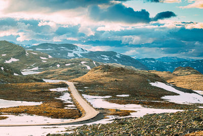 Aerial view of snowcapped mountains against sky