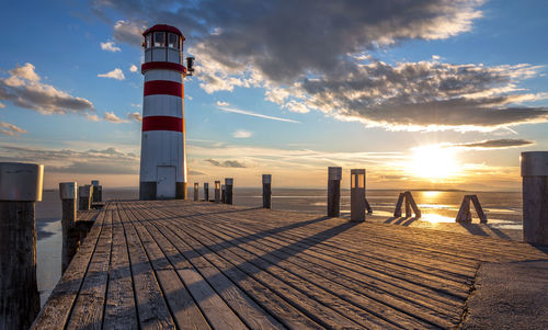 Scenic view of sea and buildings against sky during sunset