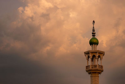 Low angle view of tower against sky during sunset