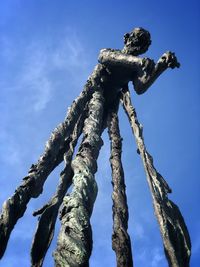 Low angle view of statue against blue sky