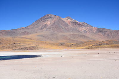 Scenic view of mountain against blue sky