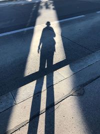 High angle view of person shadow on road