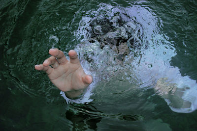 Close-up low section of man in water