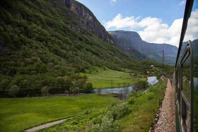 Scenic view of green mountains against sky