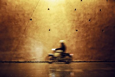 Man riding a motorcycle at night in old medina. marrakech, morocco