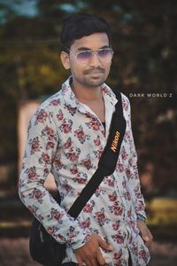 Young man wearing sunglasses standing outdoors