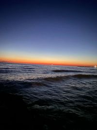 Scenic view of sea against clear sky during sunset