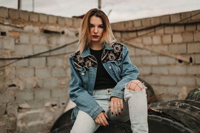 Happy young woman sitting outdoors